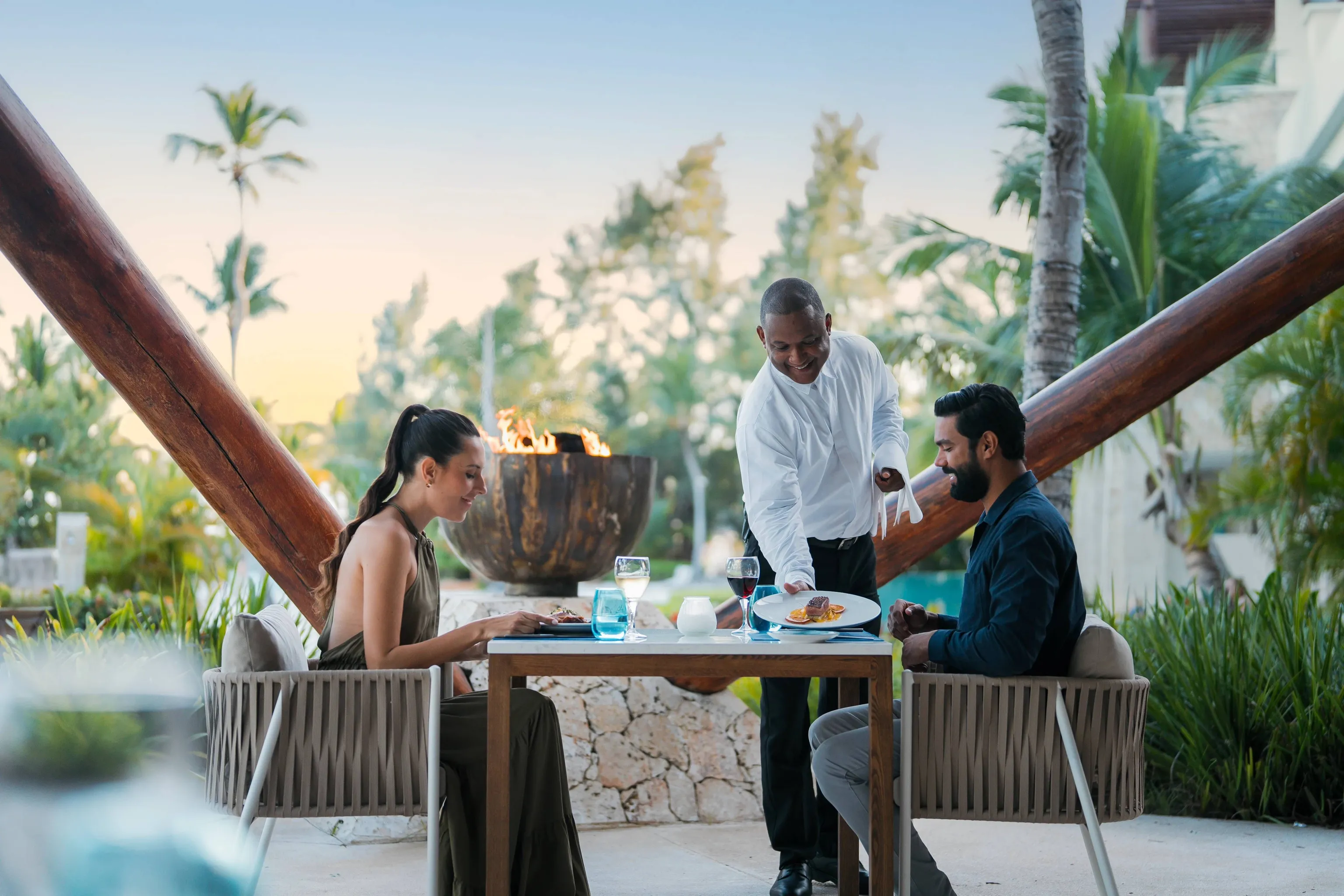 Couple enjoying a candlelit dinner at an open air restaurant at Secrets Cap Cana.